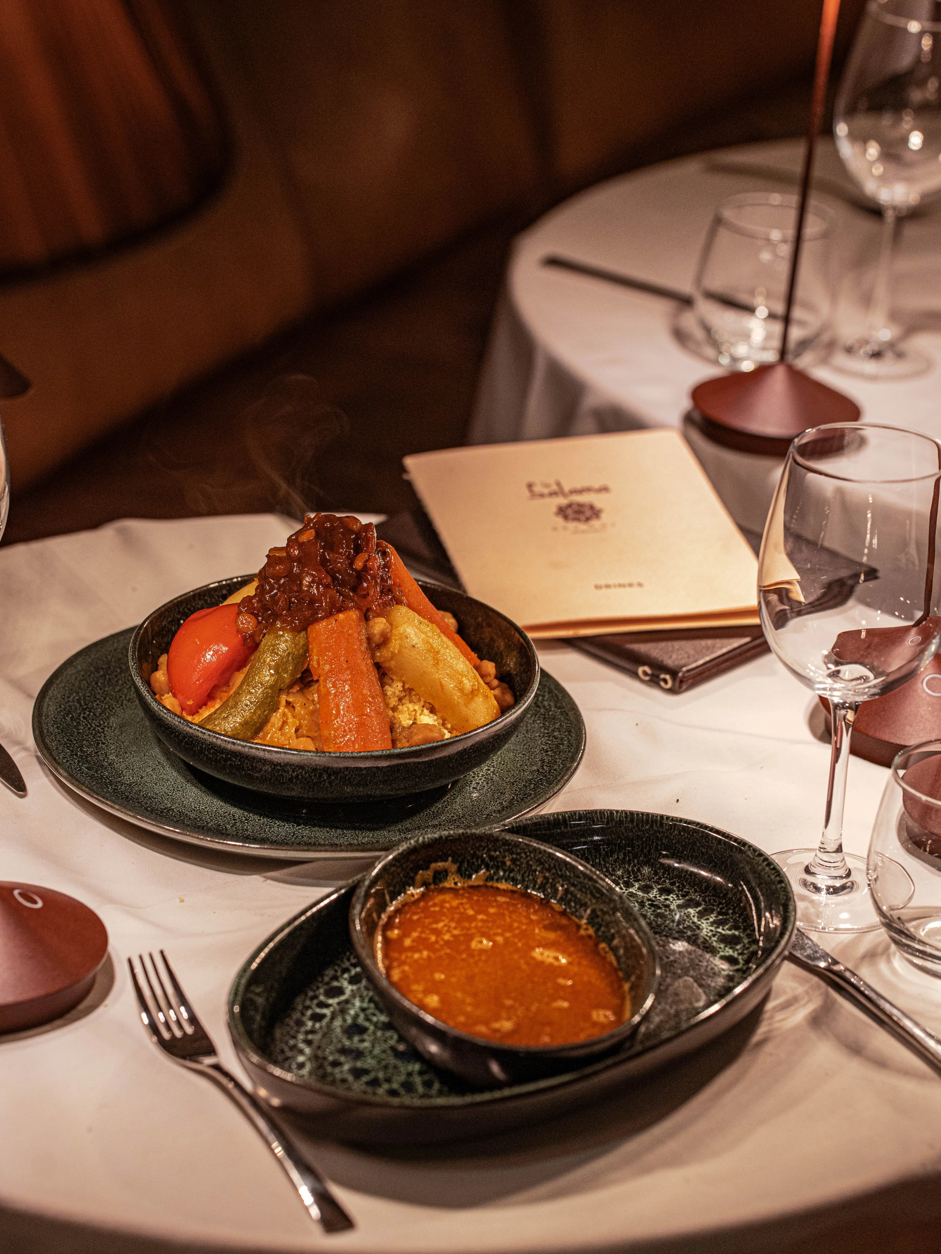Guests enjoying sunset cocktails on the Le Salama rooftop with medina views